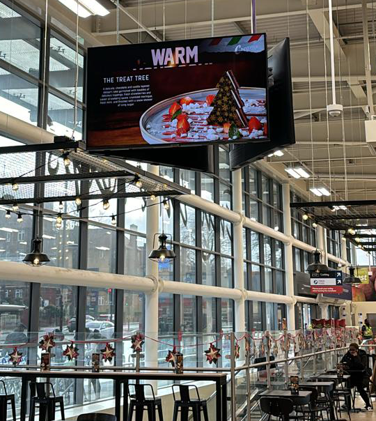 Promotional screen content in a venue
